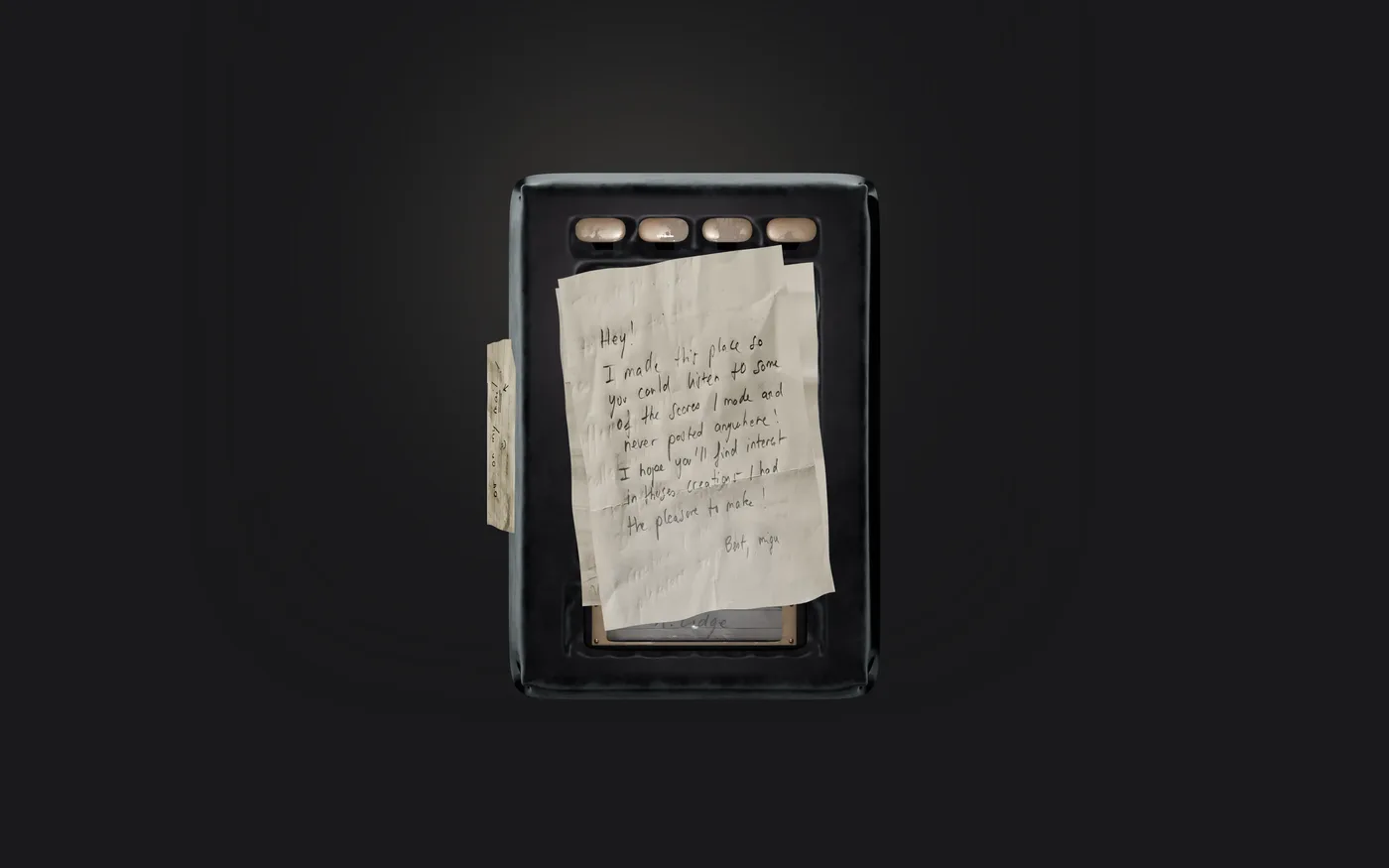 The player: a black handheld case with brass keys and a handwritten note taped over it